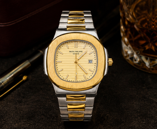 A two-tone stainless steel and yellow gold wristwatch with an octagonal bezel, gold dial, and matching two-tone link bracelet, shown against a plain white background.